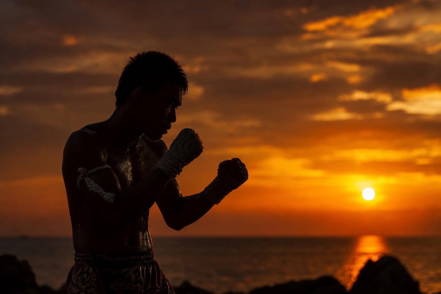 Fighter shadowboxing at sunset
